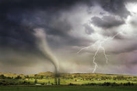 Tornado and lightning storm over rural landscape with dark clouds and green fields