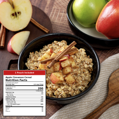 A bowl of Apple Cinnamon Cereal with oats, cinnamon sticks, and diced apple pieces, styled on a table with apples, cinnamon sticks, a spoon, and a nutrition facts label overlay in the lower left.