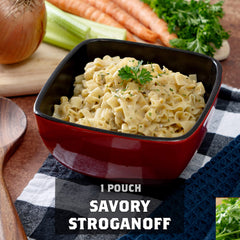 Savory stroganoff noodles in red bowl, fresh vegetables, wooden spoon, product title text
