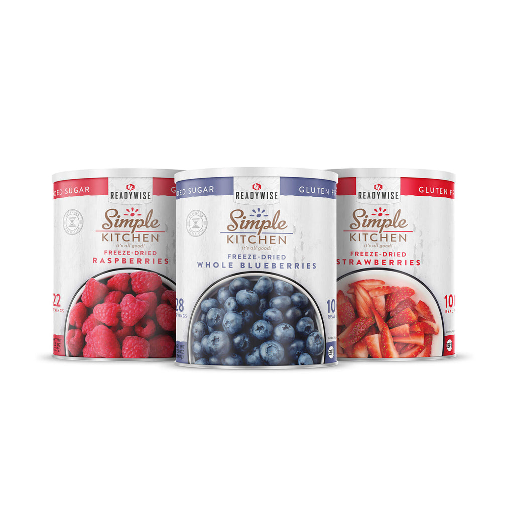 Three ReadyWise Simple Kitchen freeze-dried fruit cans: raspberries, blueberries, strawberries.